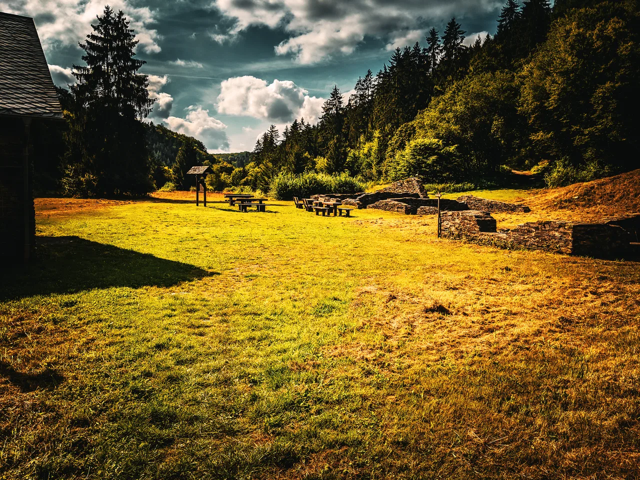 Open meadow in Kaulebachtal with old slate mining remains and forest edge